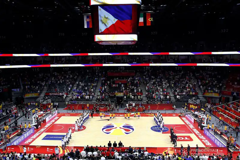 Gilas Pilipinas playing Italy at the 2019 FIBA Basketball World Cup with the Philippine flag hanging above the court